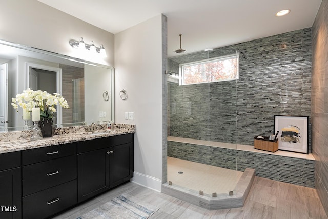 bathroom featuring walk in shower and vanity