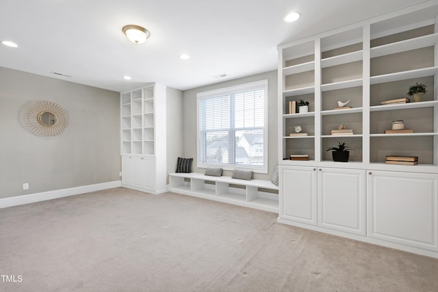 unfurnished living room featuring light colored carpet