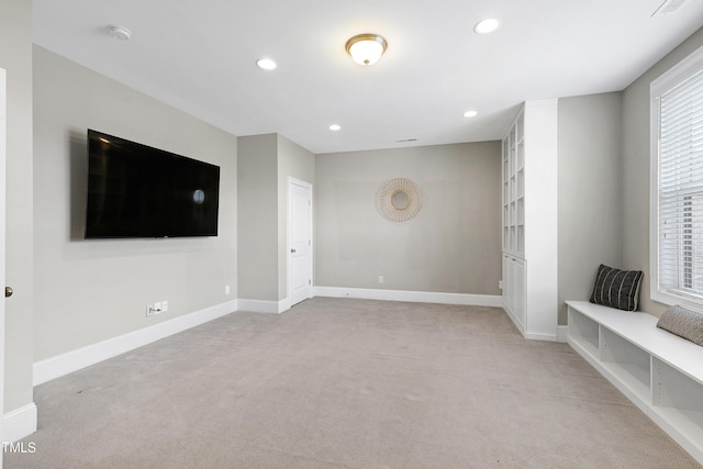 unfurnished living room with light carpet