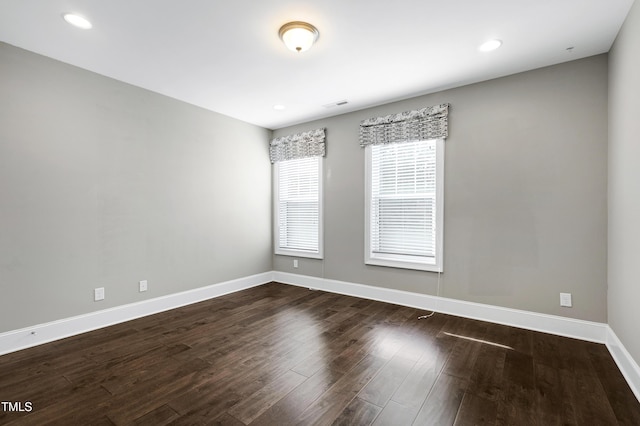 spare room featuring dark wood-type flooring