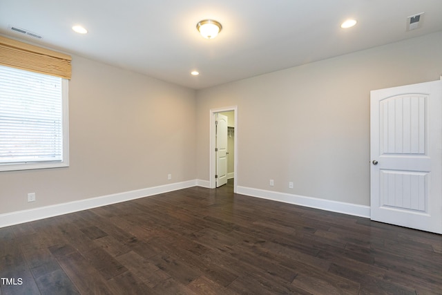 spare room featuring dark wood-type flooring