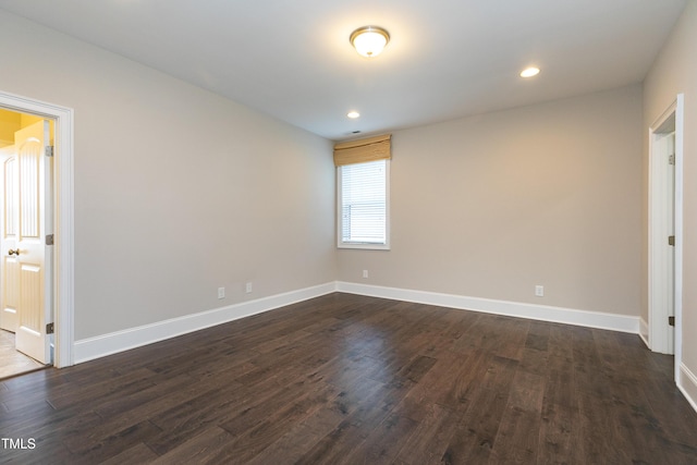 empty room featuring dark hardwood / wood-style flooring