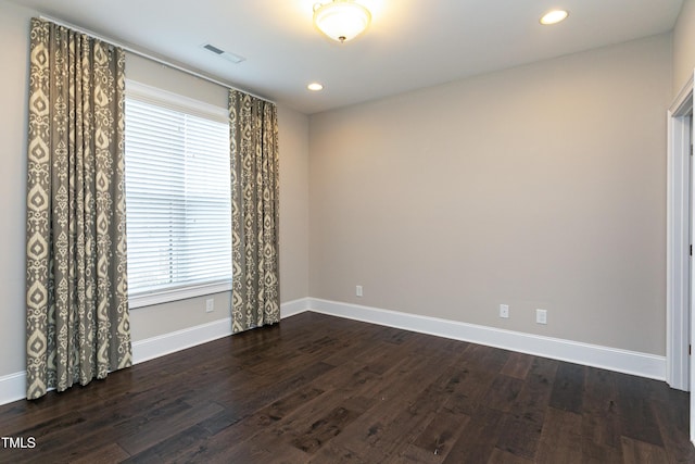 empty room featuring dark hardwood / wood-style flooring