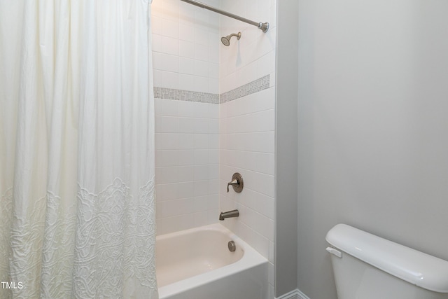 bathroom featuring shower / bathtub combination with curtain and toilet