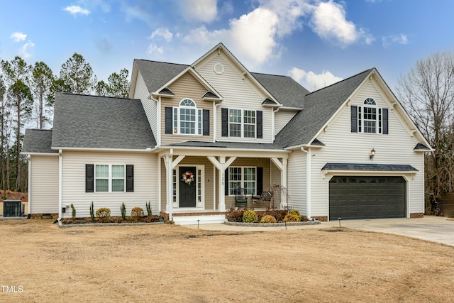 view of front of house with a porch, central AC unit, and a garage