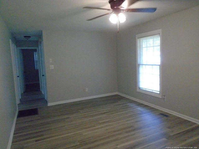 unfurnished room featuring ceiling fan and dark wood-type flooring