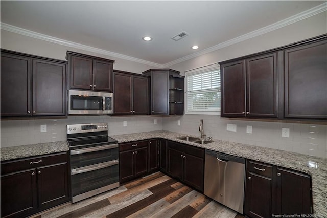 kitchen featuring sink, dark wood-type flooring, backsplash, appliances with stainless steel finishes, and ornamental molding