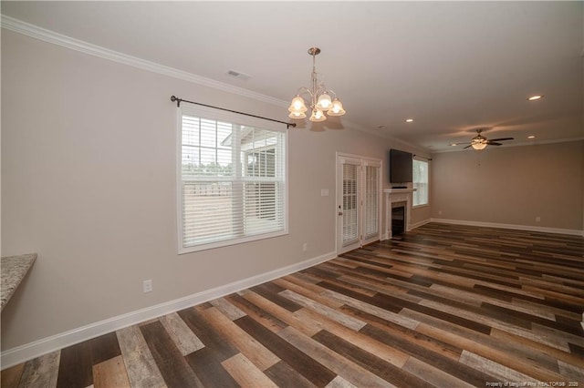 unfurnished living room featuring ceiling fan with notable chandelier, dark hardwood / wood-style floors, and crown molding