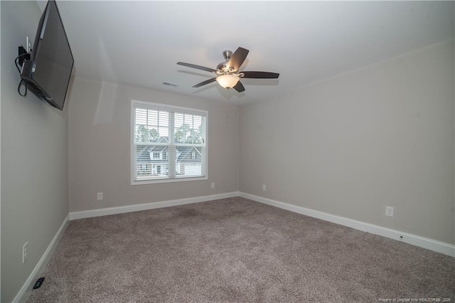 empty room with ceiling fan and carpet