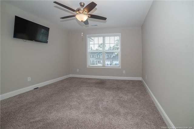 spare room featuring ceiling fan and carpet floors