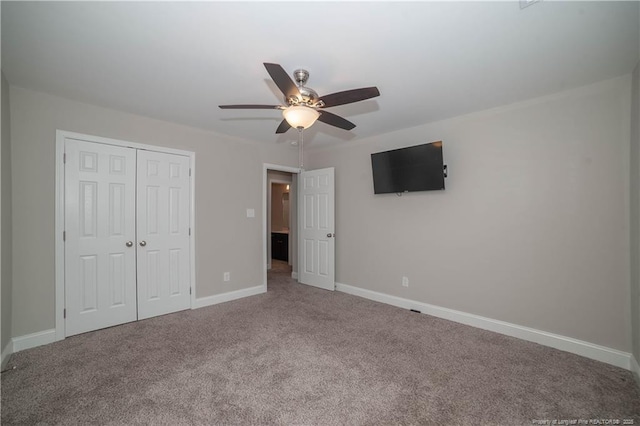 unfurnished bedroom featuring carpet flooring, ceiling fan, and a closet