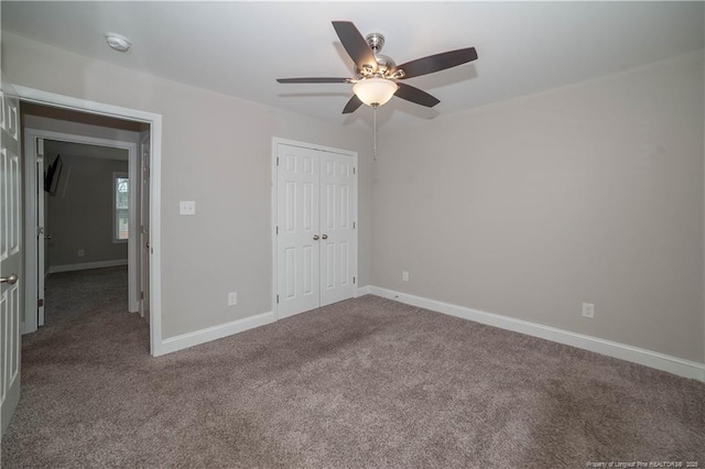 unfurnished bedroom with carpet flooring, ceiling fan, and a closet