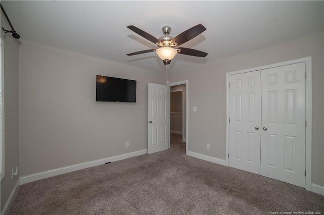 unfurnished bedroom featuring ceiling fan, carpet floors, and a closet