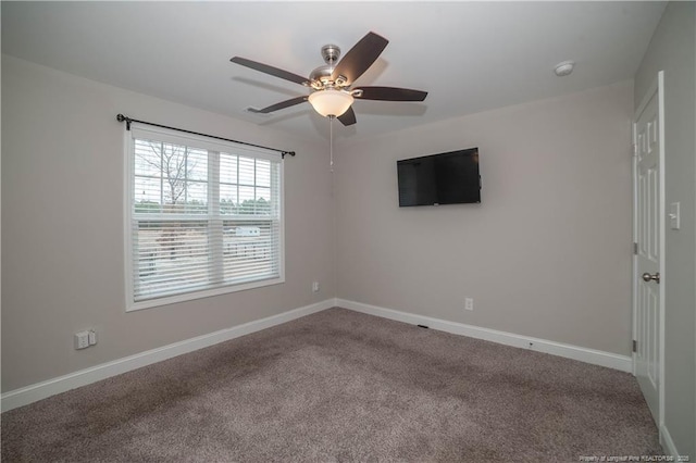 empty room featuring carpet flooring and ceiling fan