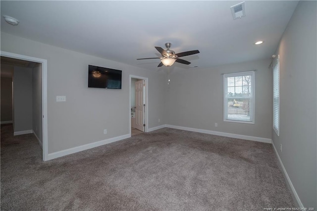 carpeted spare room with ceiling fan