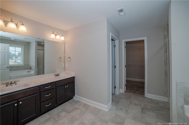 bathroom featuring vanity and a tub to relax in