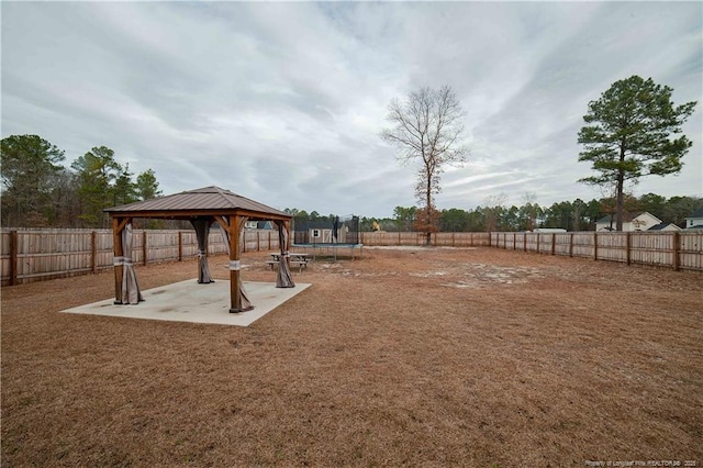 view of yard featuring a gazebo, a patio area, and a trampoline