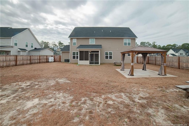 back of property with a gazebo, a sunroom, a patio area, and central air condition unit