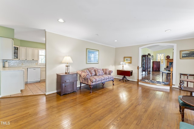 living room with ornamental molding and light wood-type flooring