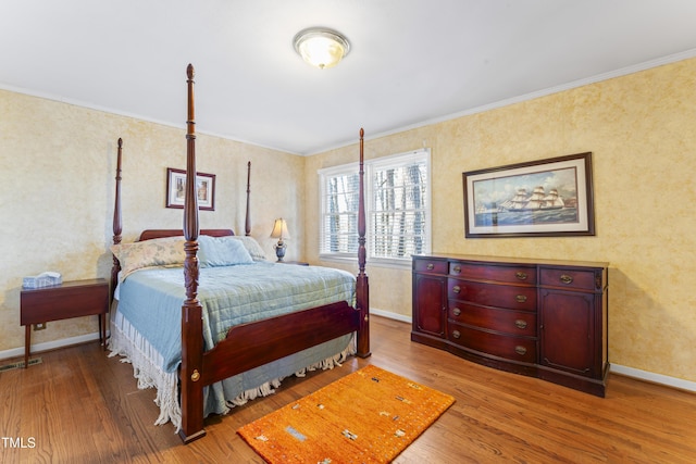 bedroom featuring hardwood / wood-style floors and ornamental molding