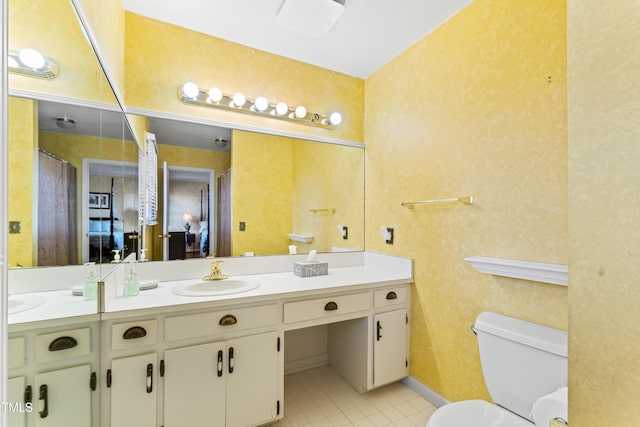 bathroom with vanity, tile patterned floors, and toilet