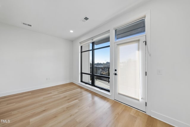 empty room with light hardwood / wood-style floors