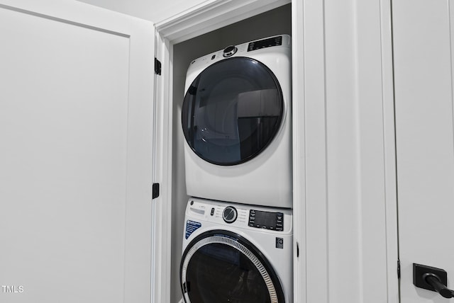 clothes washing area featuring stacked washer / drying machine