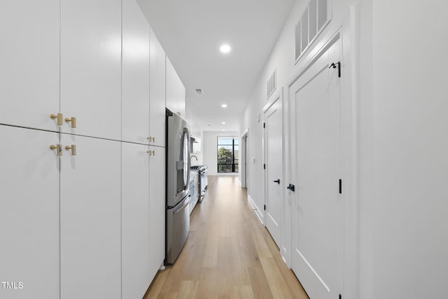 hall with light hardwood / wood-style floors