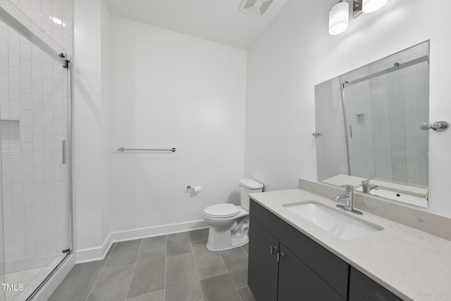 bathroom featuring vanity, tile patterned floors, a shower with door, and toilet