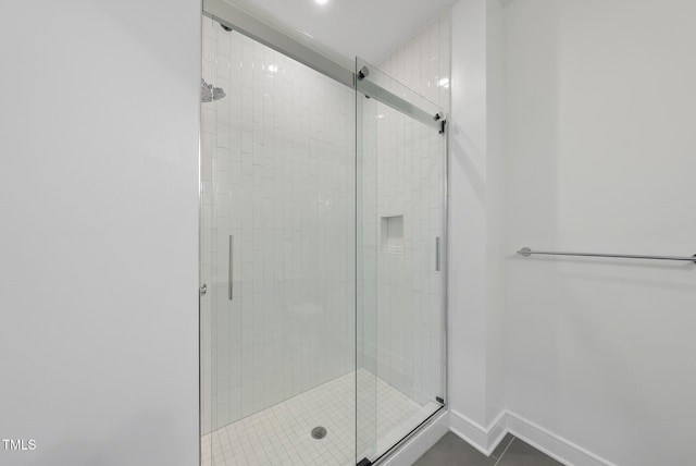 bathroom featuring tile patterned flooring and an enclosed shower