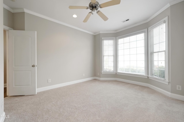 carpeted empty room with ceiling fan, a healthy amount of sunlight, and crown molding