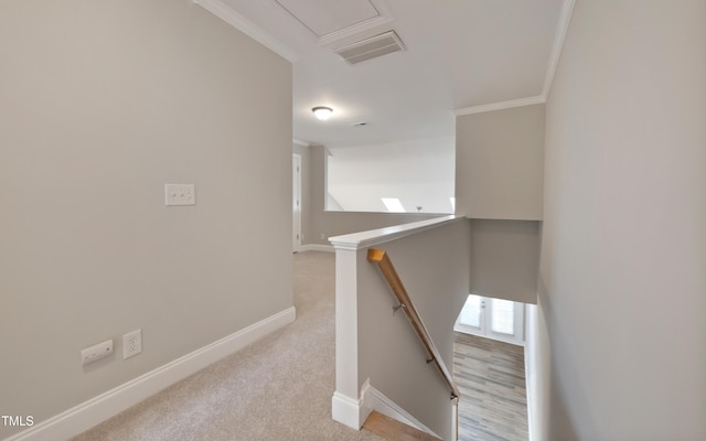 stairs featuring ornamental molding and carpet floors