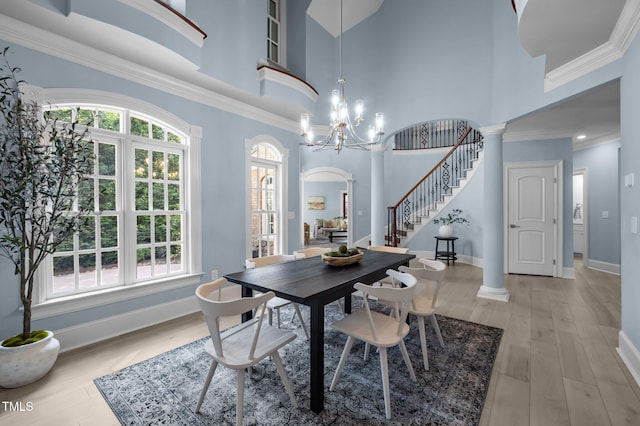 71012 Russell, Chapel Hill, NC 27517 - dining room featuring stairs, a towering ceiling, baseboards, a chandelier, and light wood-style floors