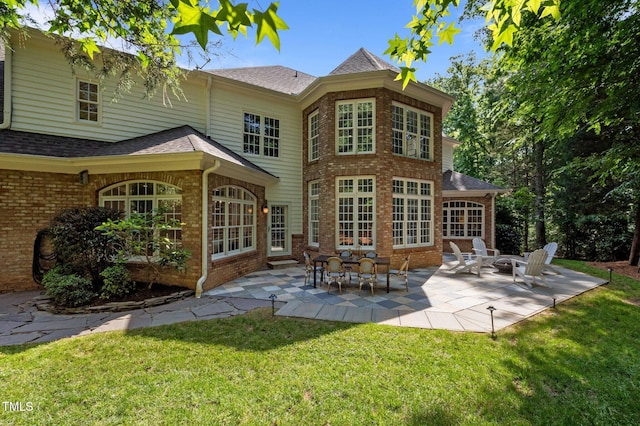 71012 Russell, Chapel Hill, NC 27517 - rear view of house featuring brick siding, a patio, and a yard
