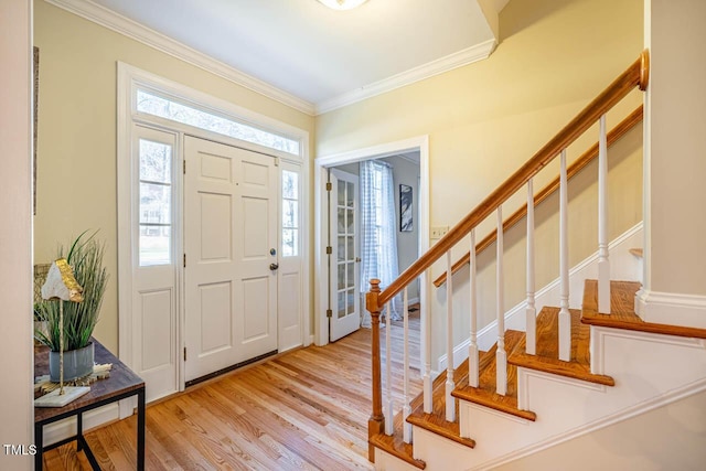 entryway featuring light hardwood / wood-style floors and crown molding