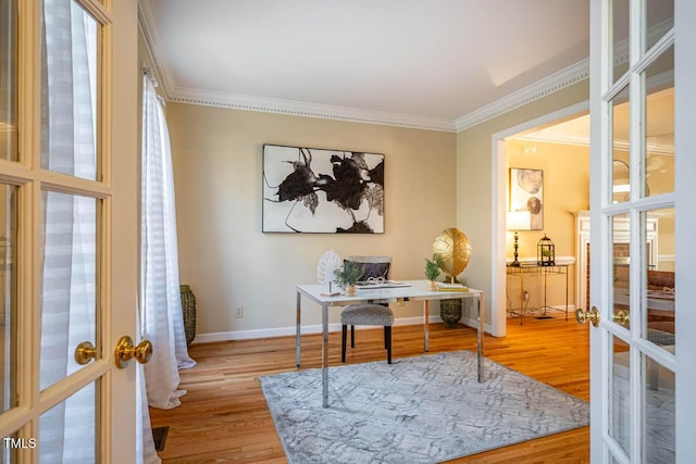 office space with ornamental molding, french doors, and light hardwood / wood-style floors