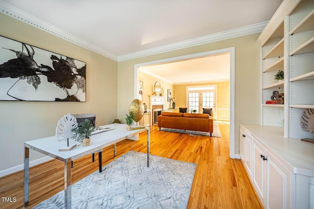 office with light wood-type flooring and ornamental molding