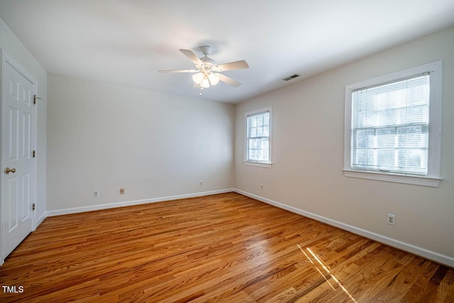 spare room featuring light wood-type flooring and ceiling fan