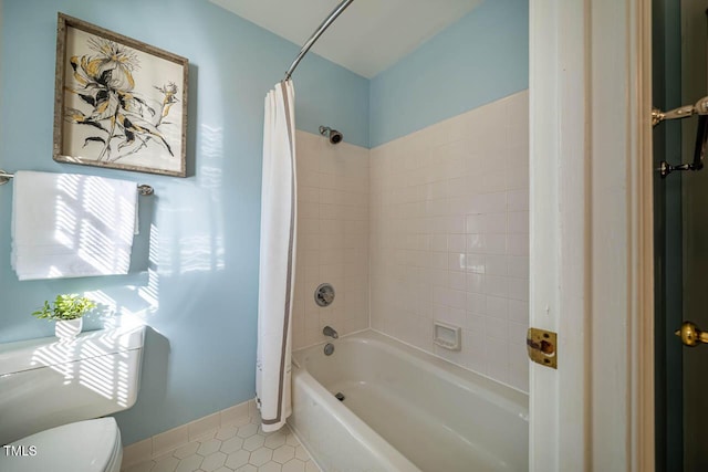 bathroom with tile patterned flooring, toilet, and shower / bath combo