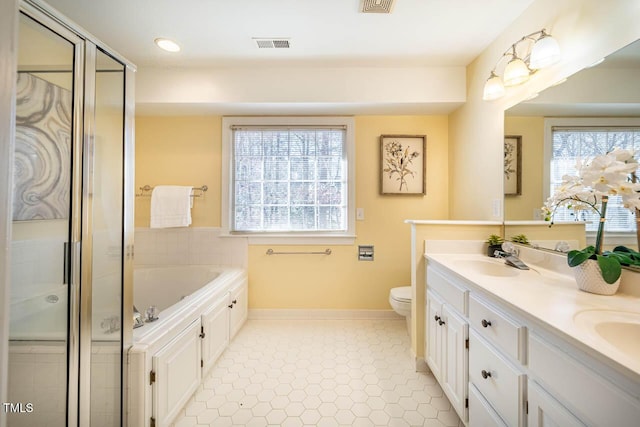 full bathroom with toilet, shower with separate bathtub, tile patterned floors, and vanity