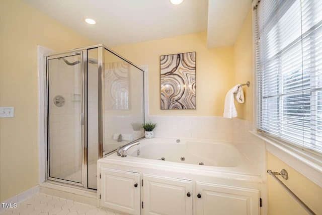 bathroom with tile patterned flooring and separate shower and tub