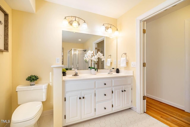 bathroom featuring walk in shower, tile patterned flooring, vanity, and toilet