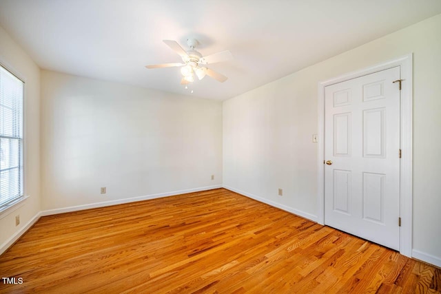 empty room featuring light wood-type flooring and ceiling fan