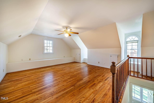 additional living space with lofted ceiling, ceiling fan, and light hardwood / wood-style flooring