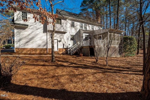 back of house with a deck and a sunroom