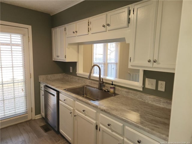 kitchen with white cabinets, a healthy amount of sunlight, dishwasher, and sink