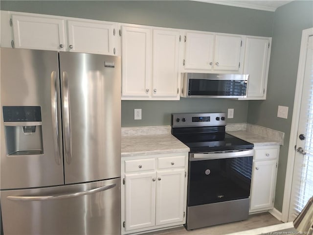 kitchen featuring white cabinetry and appliances with stainless steel finishes