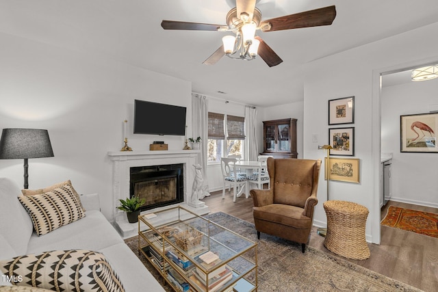 living room with ceiling fan and dark hardwood / wood-style floors