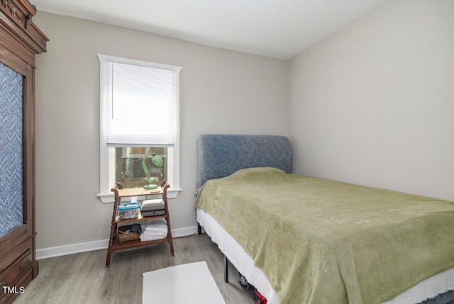 bedroom with hardwood / wood-style flooring