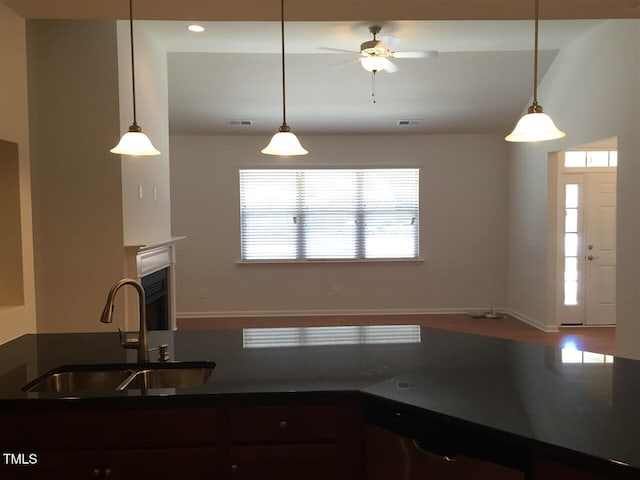 kitchen with ceiling fan, decorative light fixtures, and sink